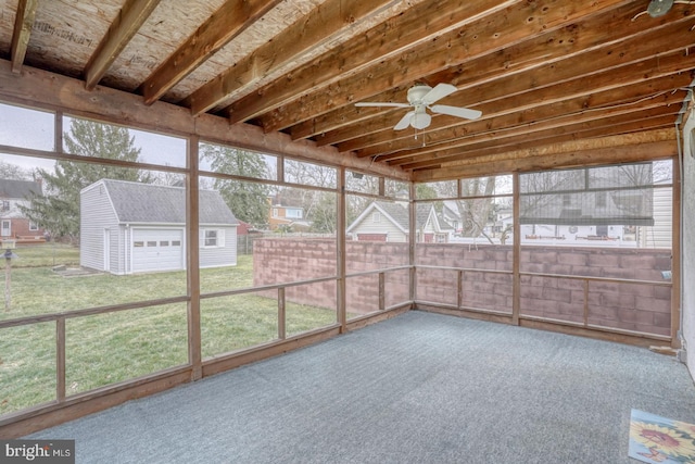 unfurnished sunroom with ceiling fan