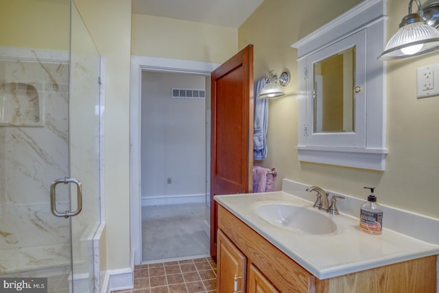 bathroom with vanity and a shower with door