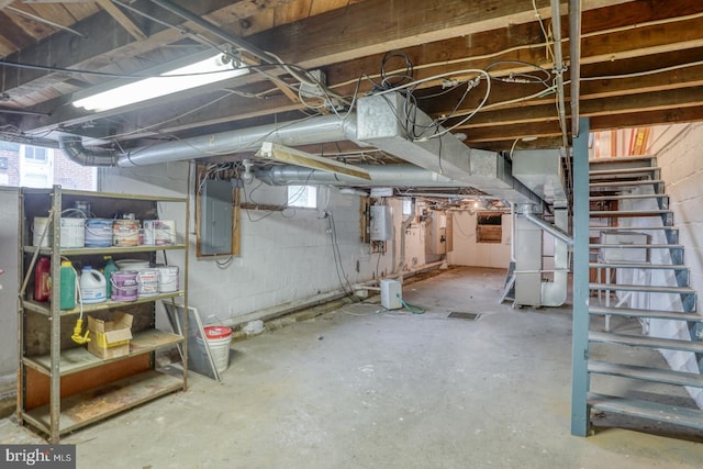 basement with electric panel, water heater, and heating unit