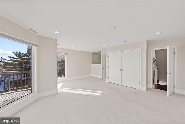 interior space featuring a closet and light carpet