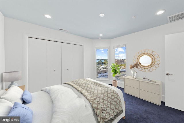 bedroom with a closet and dark colored carpet