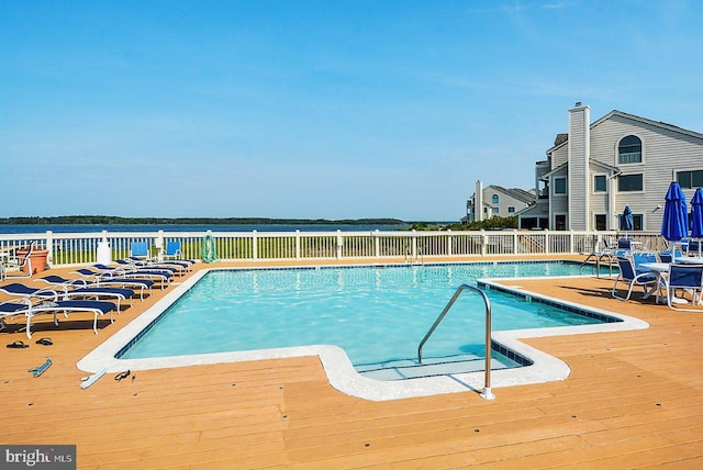 view of swimming pool with a deck with water view