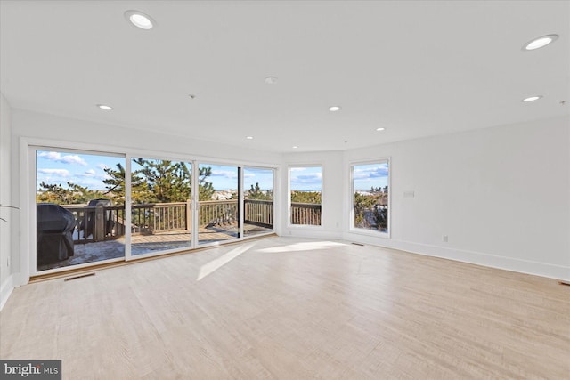 spare room featuring light wood-type flooring