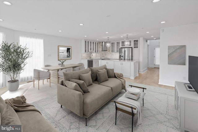 living room featuring light hardwood / wood-style floors and sink