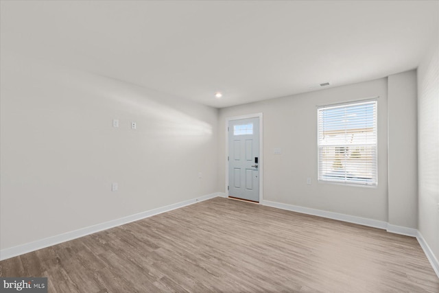 empty room with light hardwood / wood-style flooring