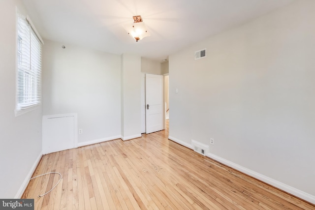 spare room featuring light hardwood / wood-style floors