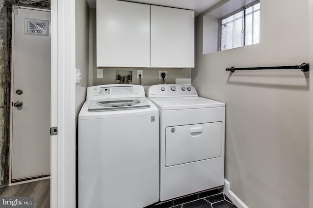 laundry area with washer and dryer and cabinets