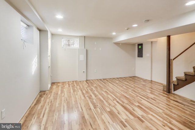 basement with light hardwood / wood-style floors