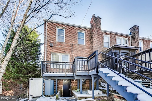 back of property featuring a wooden deck