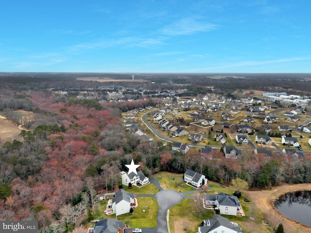 drone / aerial view featuring a residential view and a water view