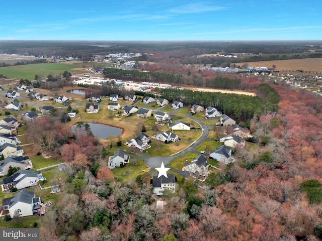 drone / aerial view featuring a residential view and a water view