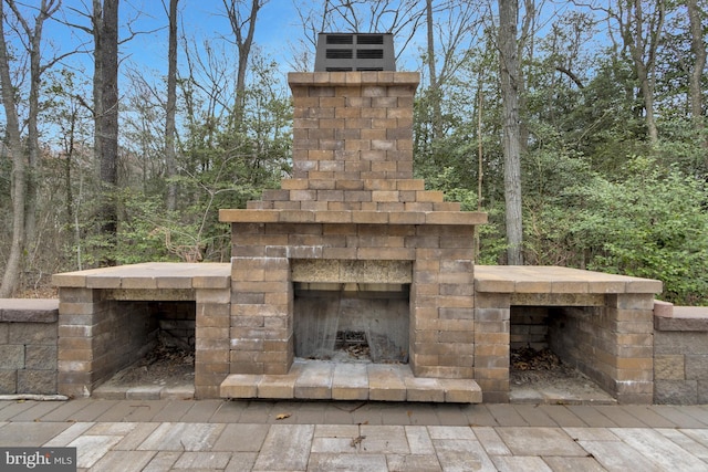 view of patio / terrace featuring an outdoor brick fireplace