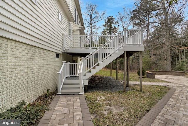 view of side of property with stairway and a wooden deck