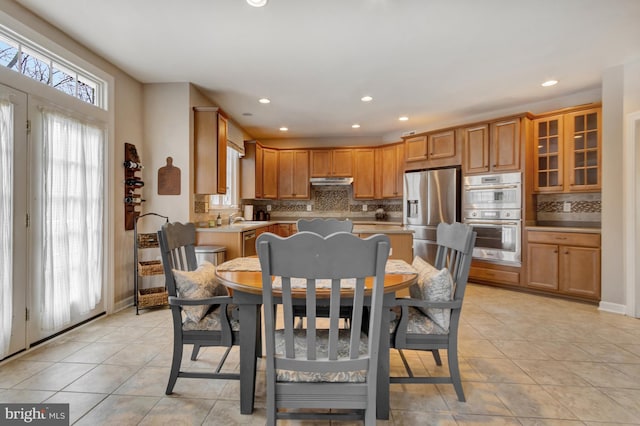 dining room featuring light tile patterned floors, recessed lighting, and baseboards