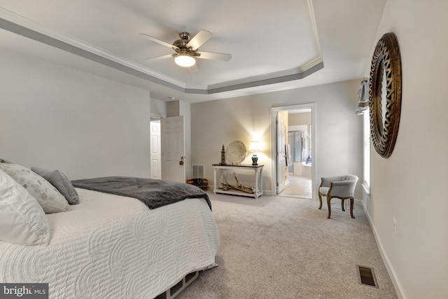 bedroom featuring visible vents, light carpet, ornamental molding, a tray ceiling, and baseboards