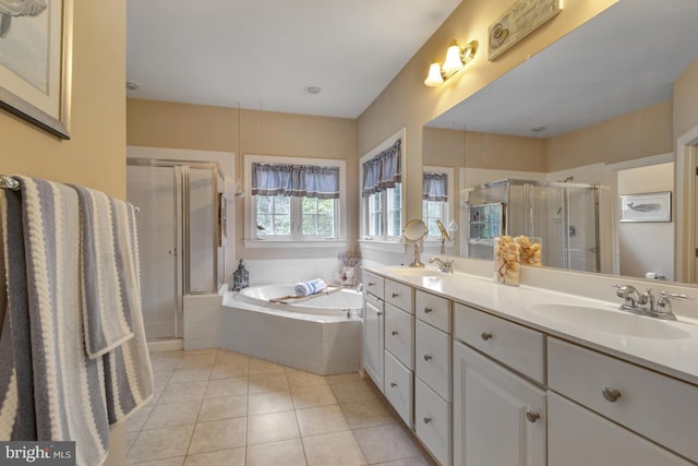 full bath with tile patterned floors, a shower stall, a garden tub, and a sink