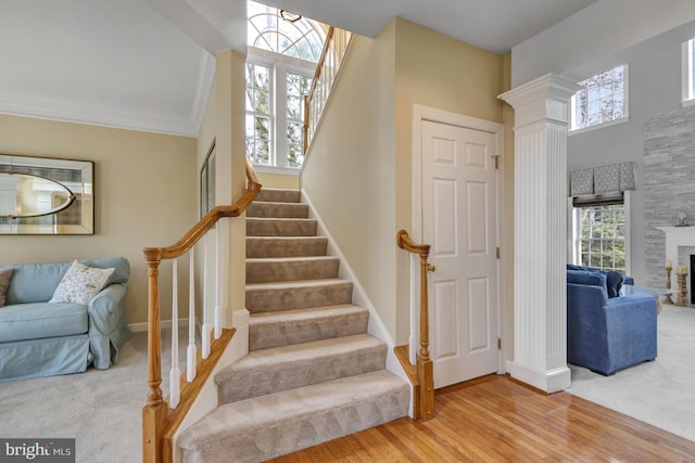 stairs featuring ornamental molding, baseboards, and wood finished floors