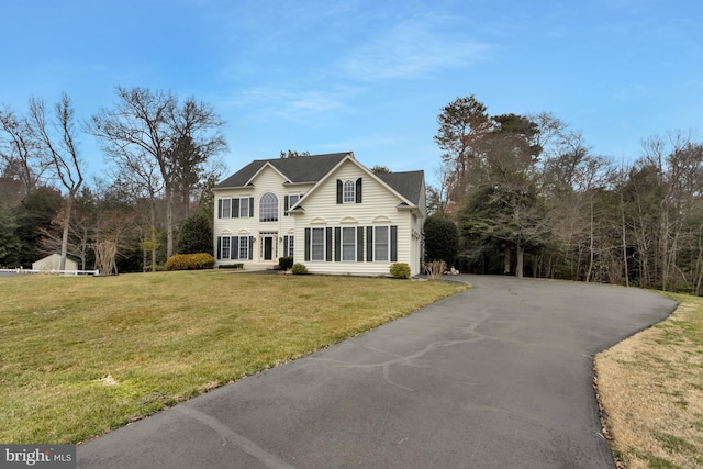 view of front of property with driveway and a front lawn