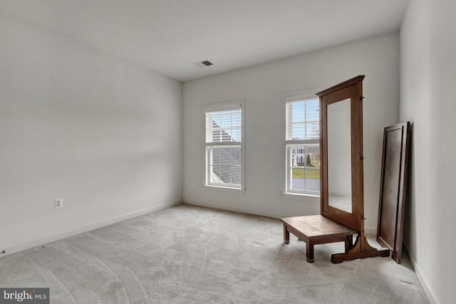 interior space featuring carpet flooring, visible vents, and baseboards