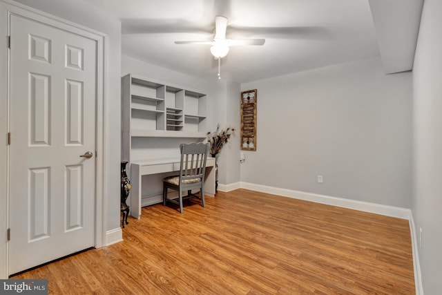 office with baseboards, light wood-style floors, and a ceiling fan