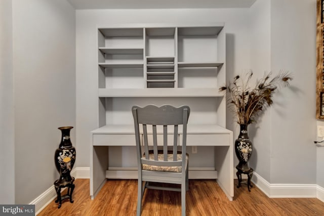 office with baseboards and wood finished floors