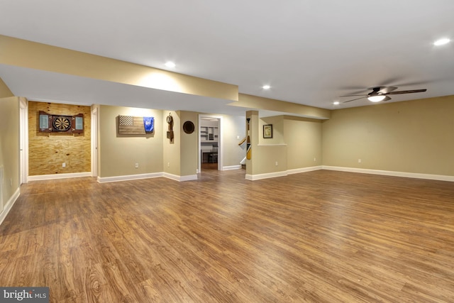 interior space featuring recessed lighting, baseboards, wood finished floors, and stairs