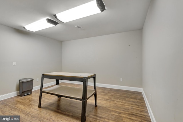 interior space with visible vents, baseboards, and wood finished floors