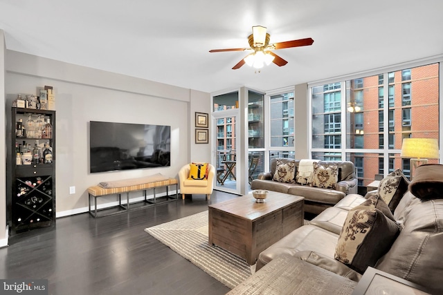 living room featuring a wall of windows, dark wood-type flooring, and ceiling fan