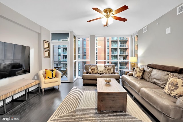 living room with dark hardwood / wood-style floors, a healthy amount of sunlight, floor to ceiling windows, and ceiling fan