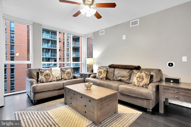 living room with ceiling fan, wood-type flooring, and a wall of windows