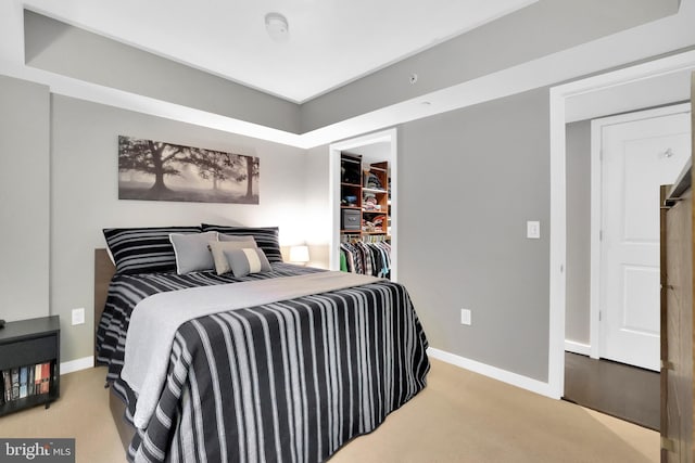 bedroom with light colored carpet and a closet