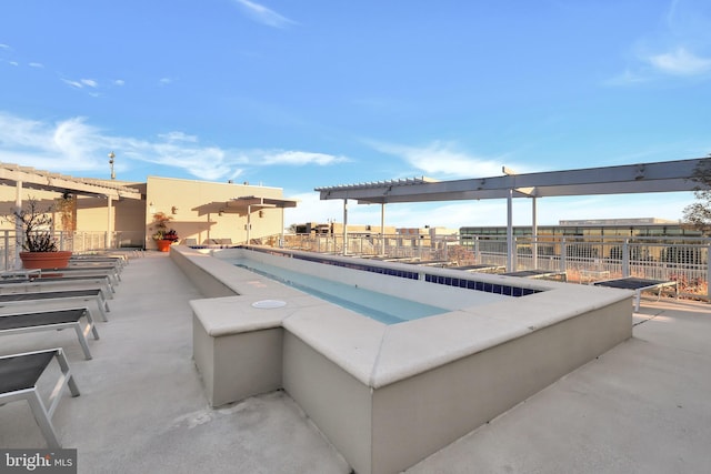 view of swimming pool featuring a hot tub