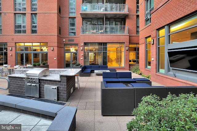 view of patio / terrace with outdoor lounge area, a grill, and an outdoor kitchen