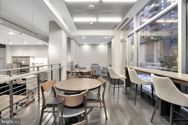 dining space with dark hardwood / wood-style flooring