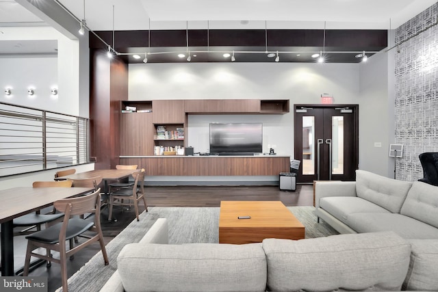 living room with wood-type flooring and a high ceiling