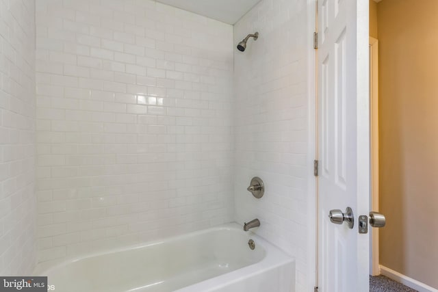 bathroom with shower / washtub combination