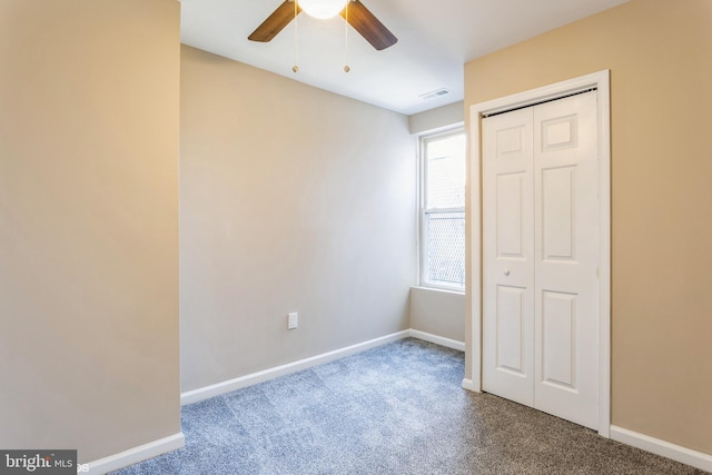 unfurnished bedroom featuring carpet flooring, a closet, and ceiling fan