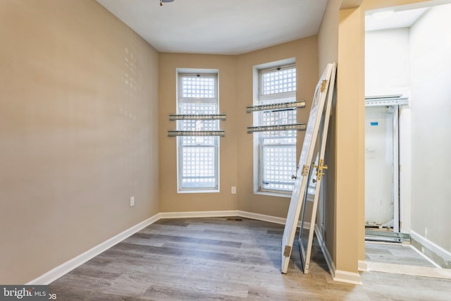 unfurnished room with hardwood / wood-style floors