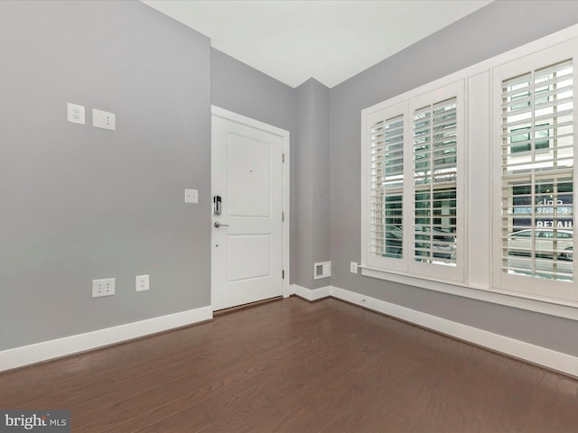 entryway with dark hardwood / wood-style flooring