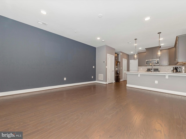 unfurnished living room featuring dark hardwood / wood-style floors