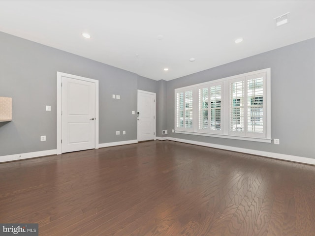 unfurnished living room featuring dark wood-type flooring