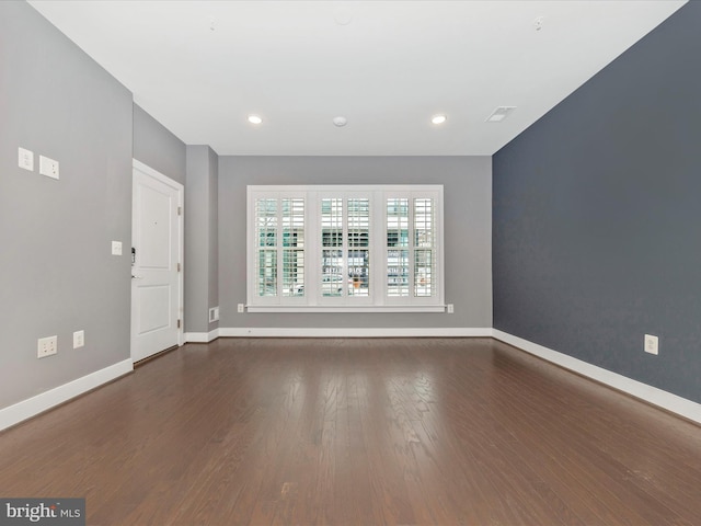 spare room featuring dark hardwood / wood-style flooring