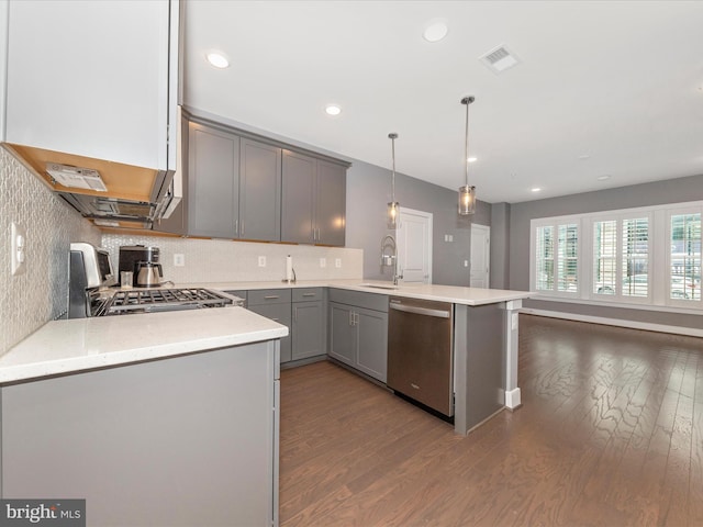 kitchen with dishwasher, kitchen peninsula, range, pendant lighting, and gray cabinetry