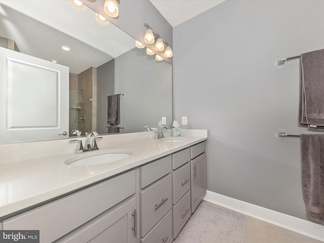 bathroom with a shower, vanity, and tile patterned floors