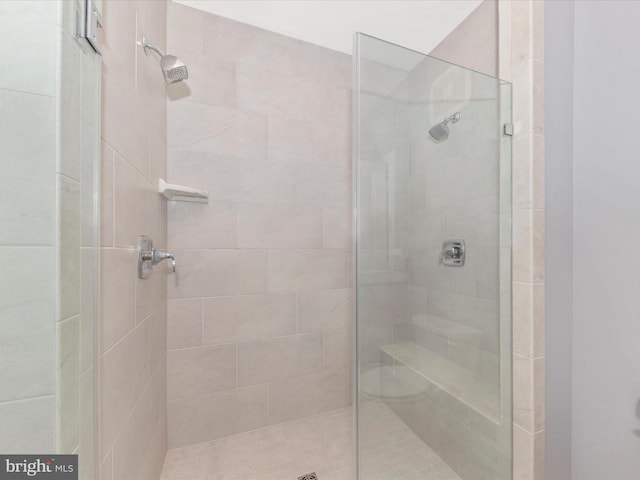 bathroom with a tile shower