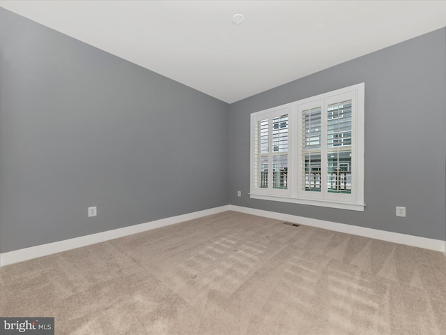 unfurnished room with light carpet