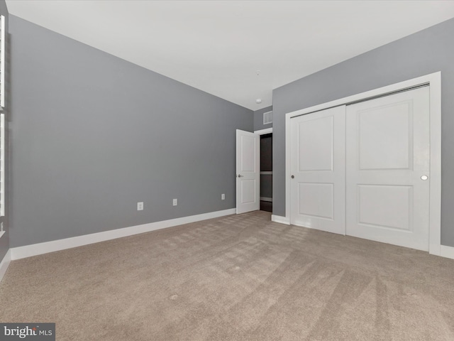 unfurnished bedroom featuring a closet and carpet