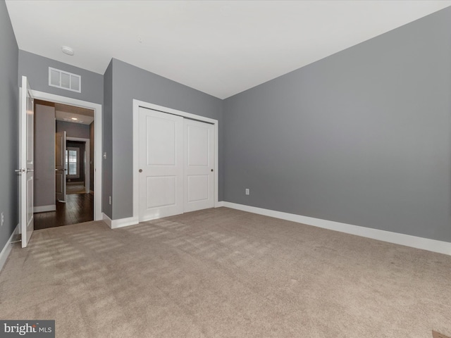 unfurnished bedroom featuring a closet and carpet