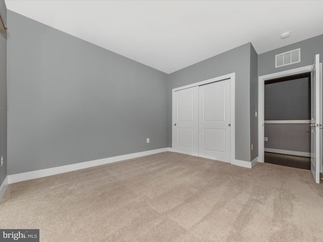 unfurnished bedroom featuring a closet and carpet