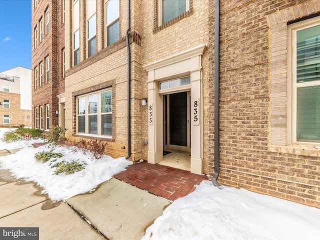 view of snow covered property entrance